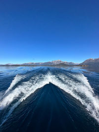 Scenic view of snowcapped mountains against clear blue sky