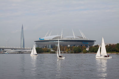 Sailboats sailing in sea against sky
