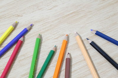 Close-up of multi colored pencils on table