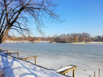 Scenic view of frozen lake against clear blue sky