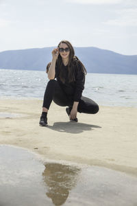 Full length of young woman on beach