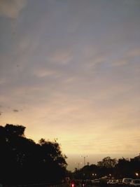 Silhouette trees against sky at sunset