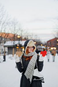 Rear view of woman holding umbrella