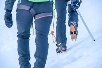 Two athletes hiking up a glacier on mt. baker from the waist down