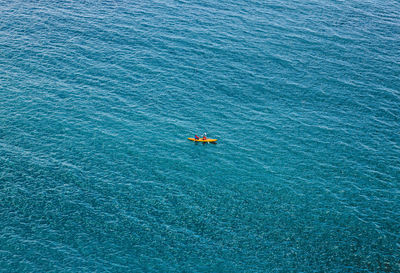 Distant view of kayak on sea