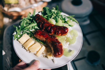 Close-up of hand holding salad