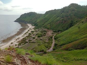 Scenic view of sea and mountains against sky