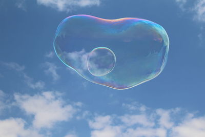 Low angle view of bubbles against sky