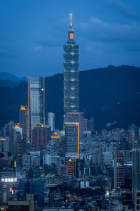 Illuminated buildings in city at dusk