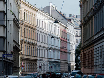 Traffic on road amidst buildings in city