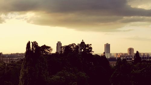 View of cityscape against cloudy sky