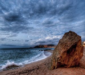 Scenic view of sea against storm clouds