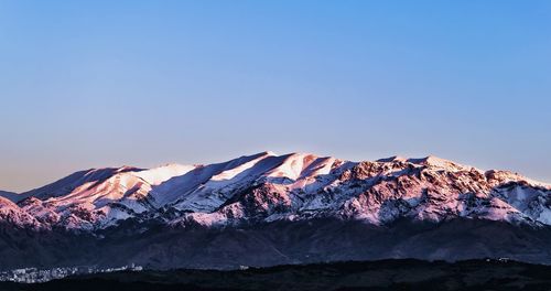 Scenic view of mountains against blue sky