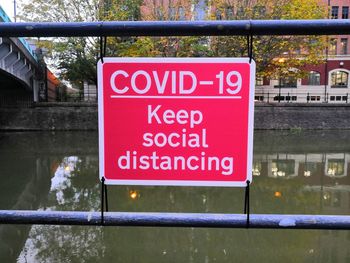 Covid 19 keep social distancing sign on railing