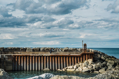 View of dam on sea against sky