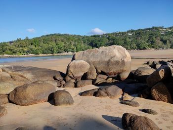 Rocks by sea against sky