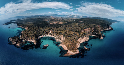 High angle view of surf on sea shore against sky