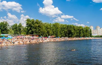 People at beach against sky