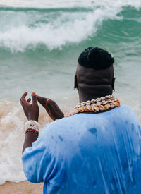 Rear view of couple standing on beach