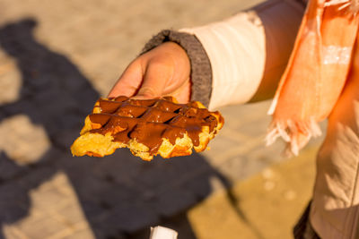 Close-up of hand holding ice cream