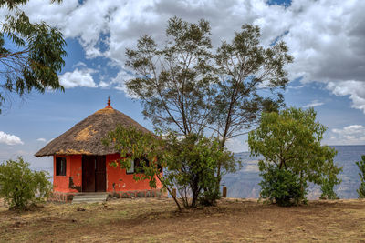 Built structure on field against sky