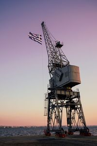 Crane against clear sky at sunset