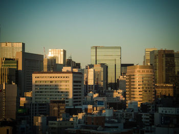 Modern buildings in city against clear sky