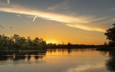 Scenic view of lake against sky during sunset