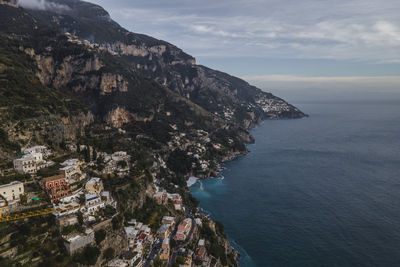 High angle view of townscape by sea against sky