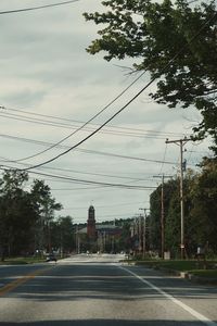 Road by city against sky