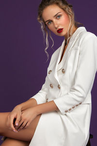 Portrait of a beautiful young woman over gray background