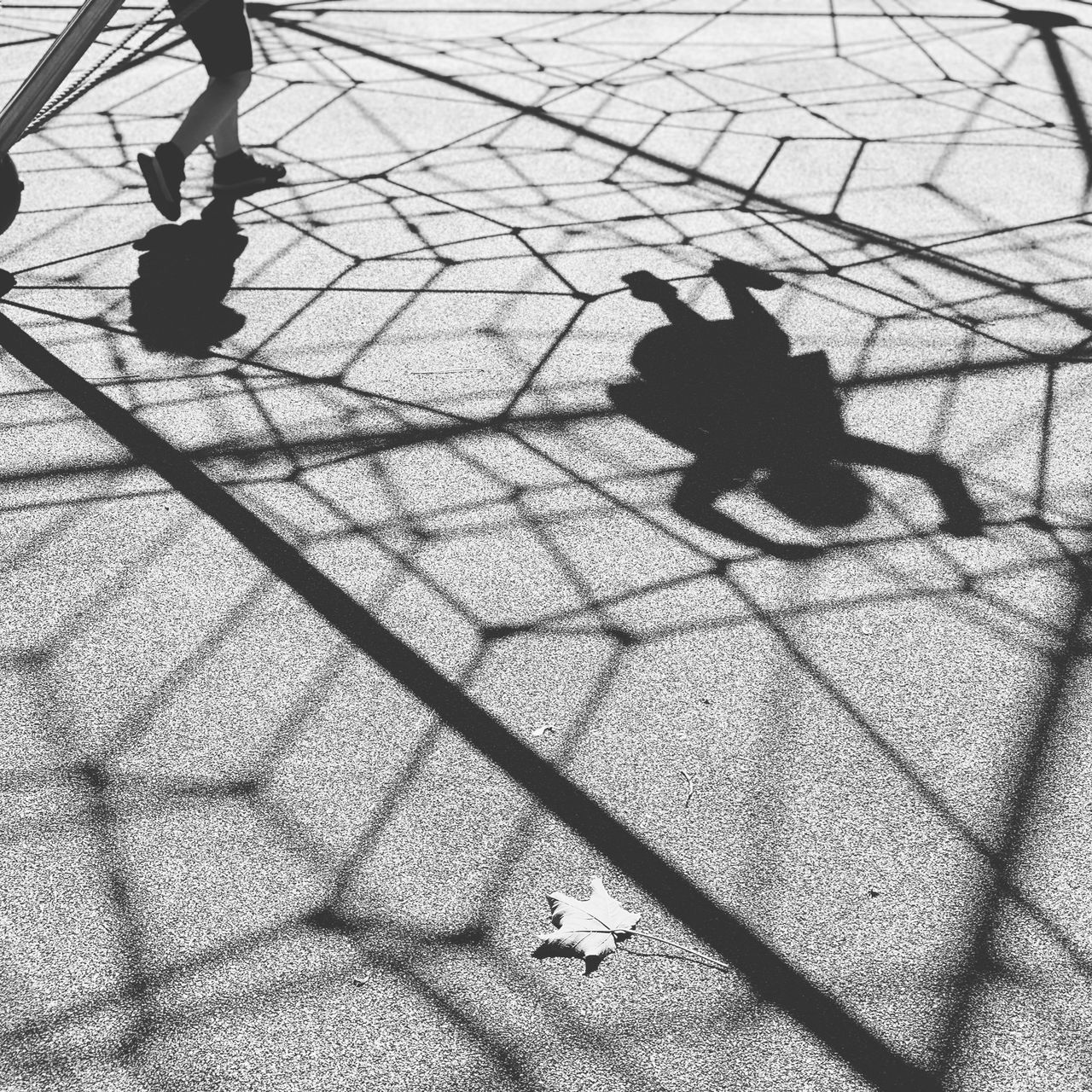 HIGH ANGLE VIEW OF SHADOW ON STREET