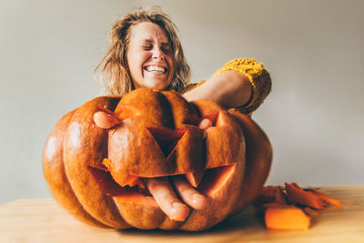 Portrait of woman holding pumpkin