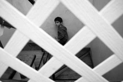 High angle portrait of boy standing on staircase