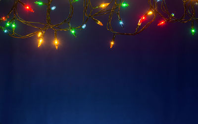 Low angle view of illuminated tree against sky at night