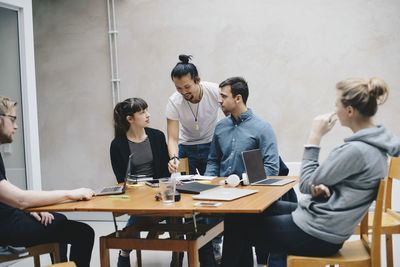 Multi-ethnic computer programmers working at desk in office