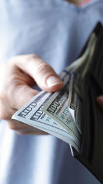 A girl with a wallet and money in her hands, united states one-hundred-dollar bill