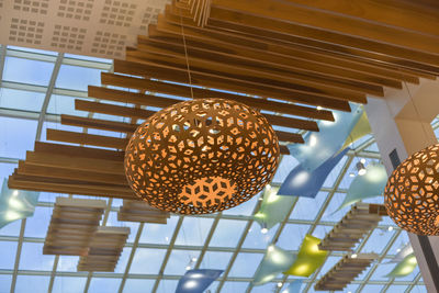 Low angle view of lanterns hanging on ceiling in building