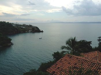 High angle view of houses by sea against sky