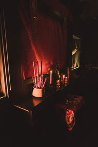 Close-up of illuminated lamp on table at home