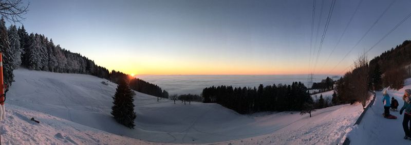 Scenic view of snow covered landscape against sky during sunset