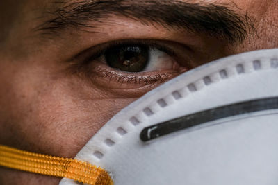 Man eye portrait details dressing corona virus covid-19 protective mask,disease