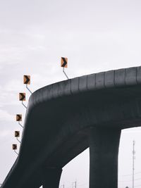 Low angle view of road signal against sky