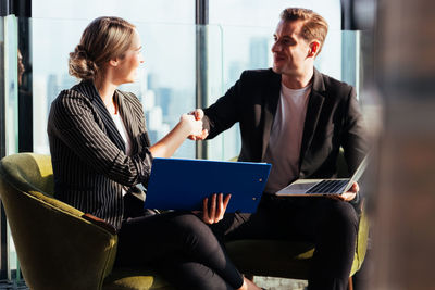 Young woman using mobile phone in office