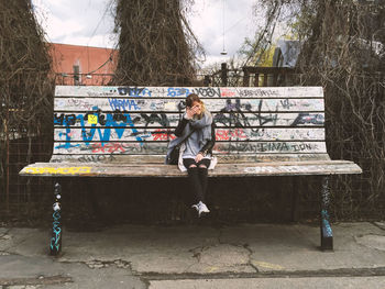 Full length of woman standing by railing