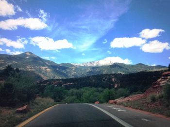 Empty road leading towards mountains