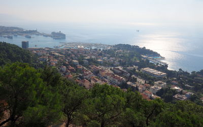 High angle view of townscape by sea against sky