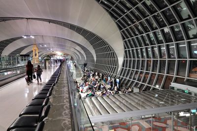People walking on escalator in city