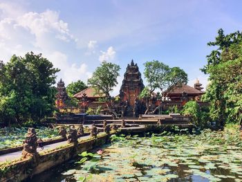 Temple and pond against sky