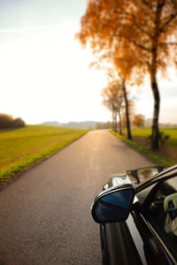 Close-up of car on road against sky